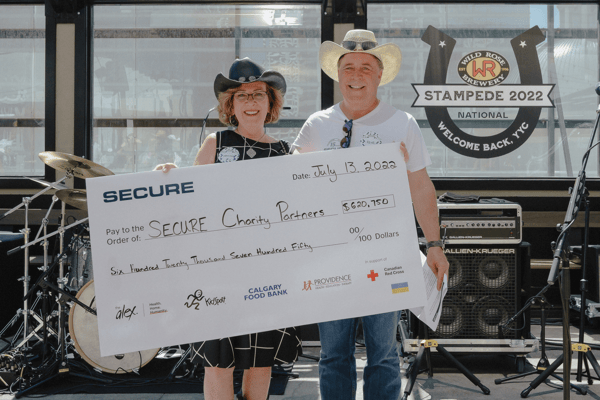 Rene and Marguerite Amirault present cheque at charity party